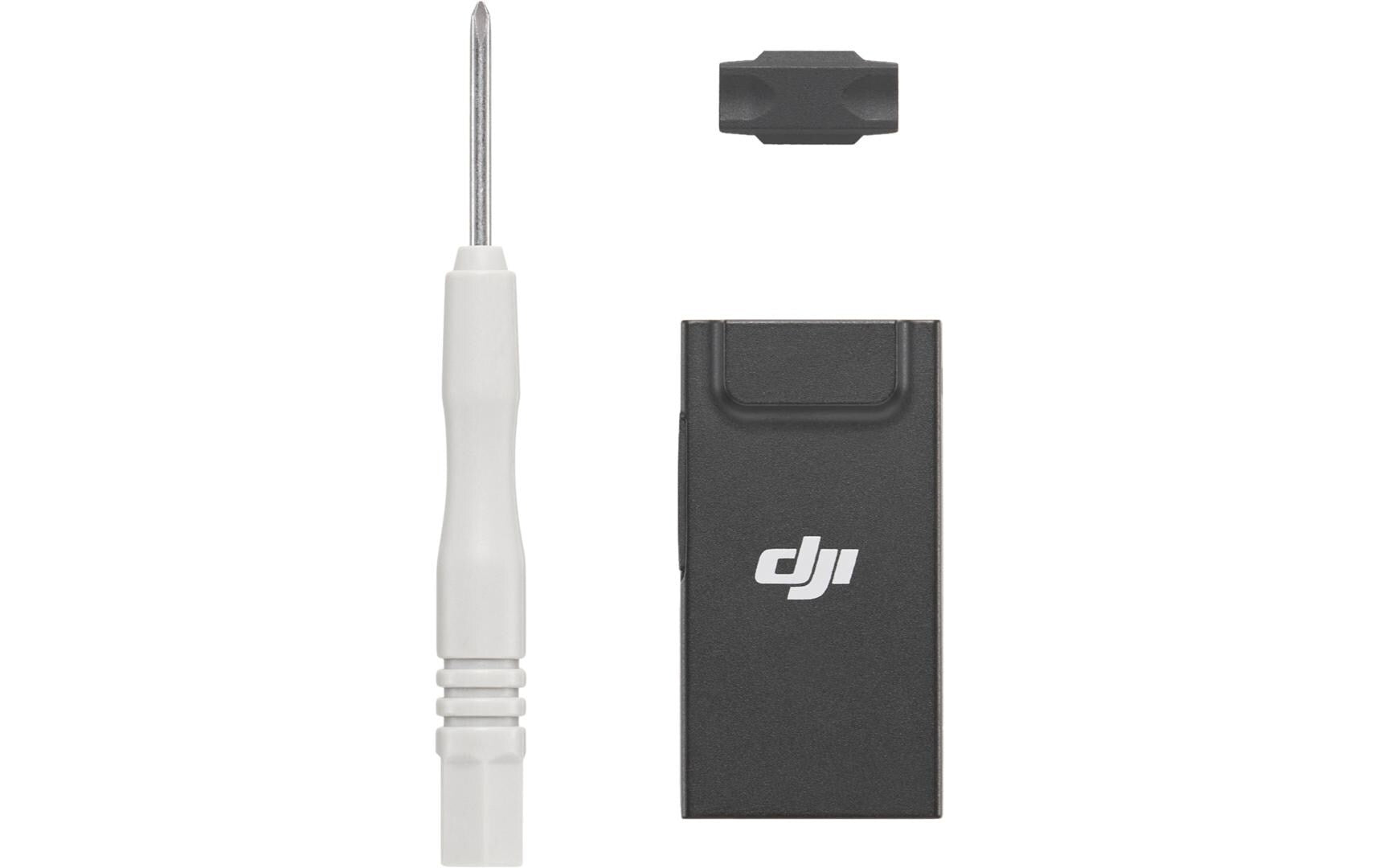 Ein schwarzer DJI Enterprise DJI Cellular Dongle 2 ist neben einem Schraubenzieher mit weißem Griff und einem kleinen schwarzen Zubehör positioniert und ergänzt die elegante Designästhetik des DJI Mini 4 Pro auf einem makellos weißen Hintergrund perfekt.