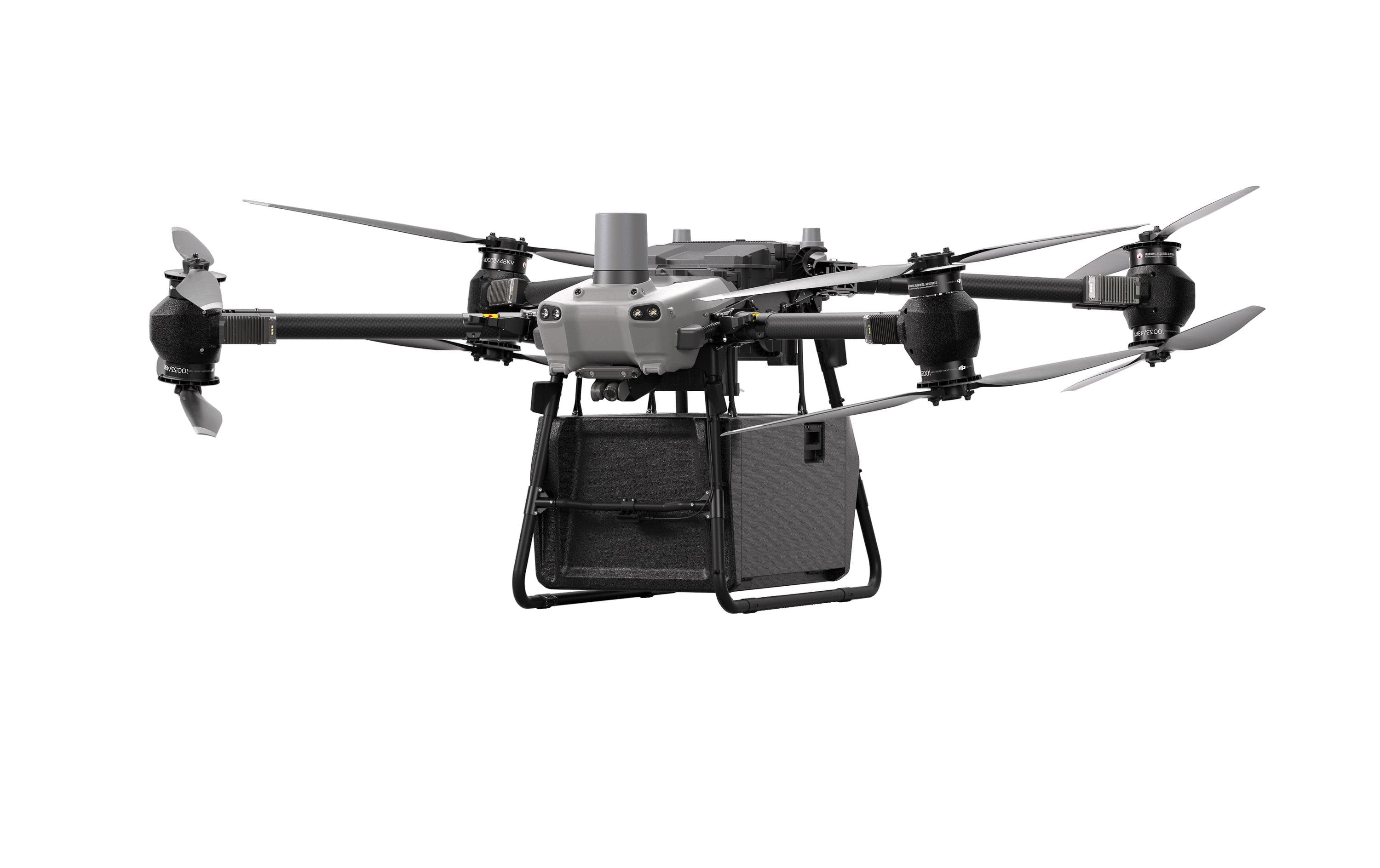 Der DJI Delivery Multikopter – FlyCart 30 von DJI Delivery ist ein großer Quadrocopter mit vier Propellern und einer darunter montierten schwarzen rechteckigen Frachtbox, die isoliert auf weißem Hintergrund dargestellt ist.