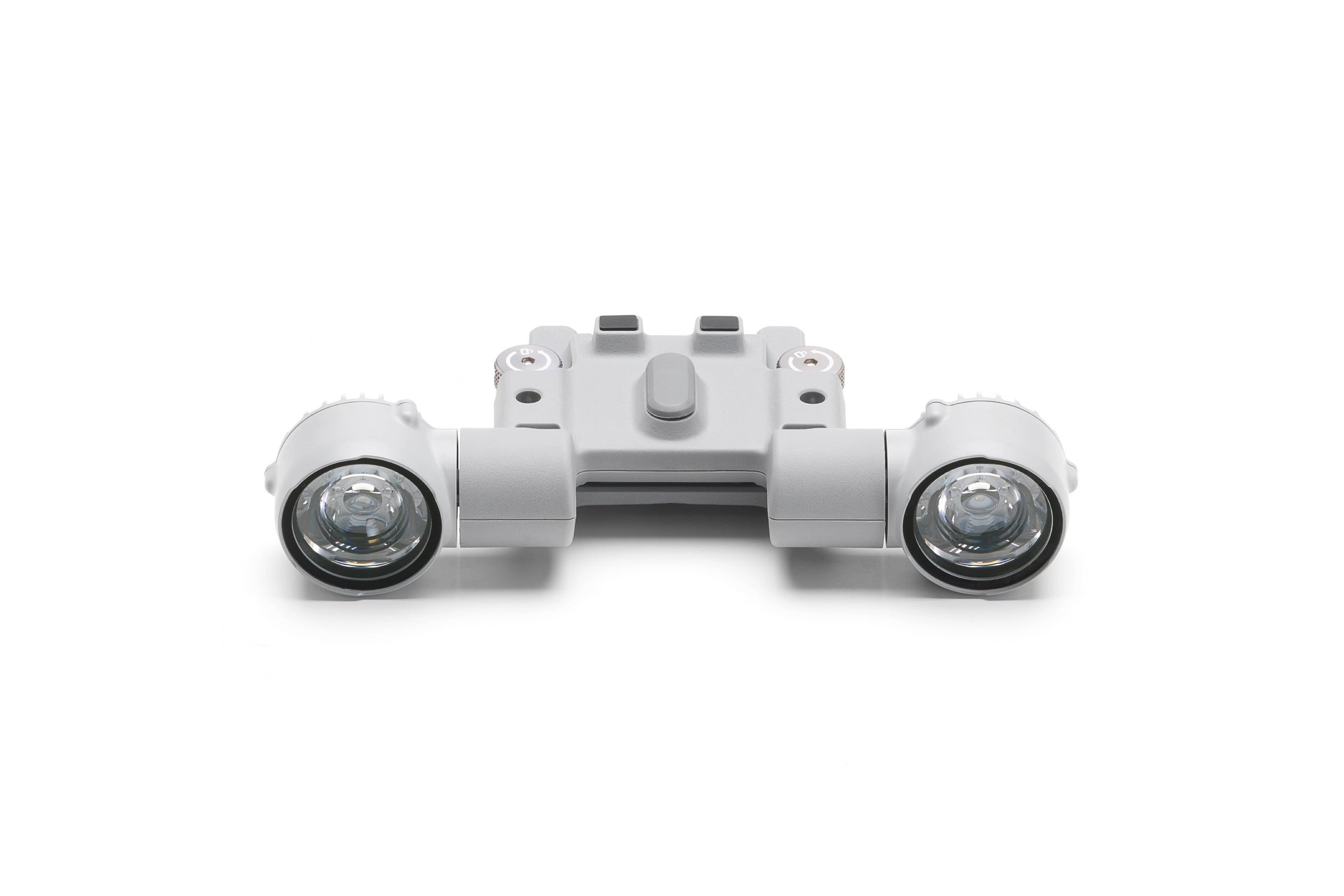 Nahaufnahme eines grauen Kunststoffgeräts, das dem DJI AL1 Scheinwerfer – Spotlight für die M4 Serie von DJI Enterprise ähnelt, mit zylindrischen Komponenten und klaren Linsen, strukturierter Mittelfläche mit sichtbaren Schrauben vor weißem Hintergrund, ideal für verschiedene Beleuchtungsmodusoptionen.