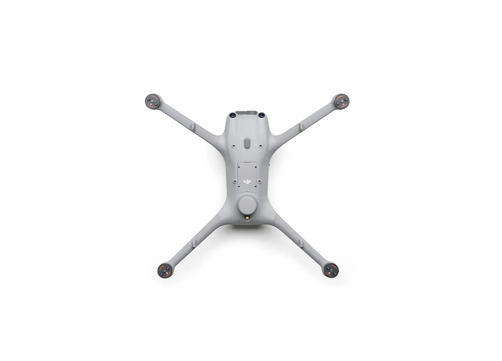 Eine Draufsicht auf die graue DJI Matrice 4TD Stand-Alone Combo (M4TD) von DJI Enterprise, eine IP55-Allwetterdrohne mit vier Armen und Propellern, die für Wärmebildanalysen entwickelt wurde, dargestellt auf einem schlichten weißen Hintergrund.