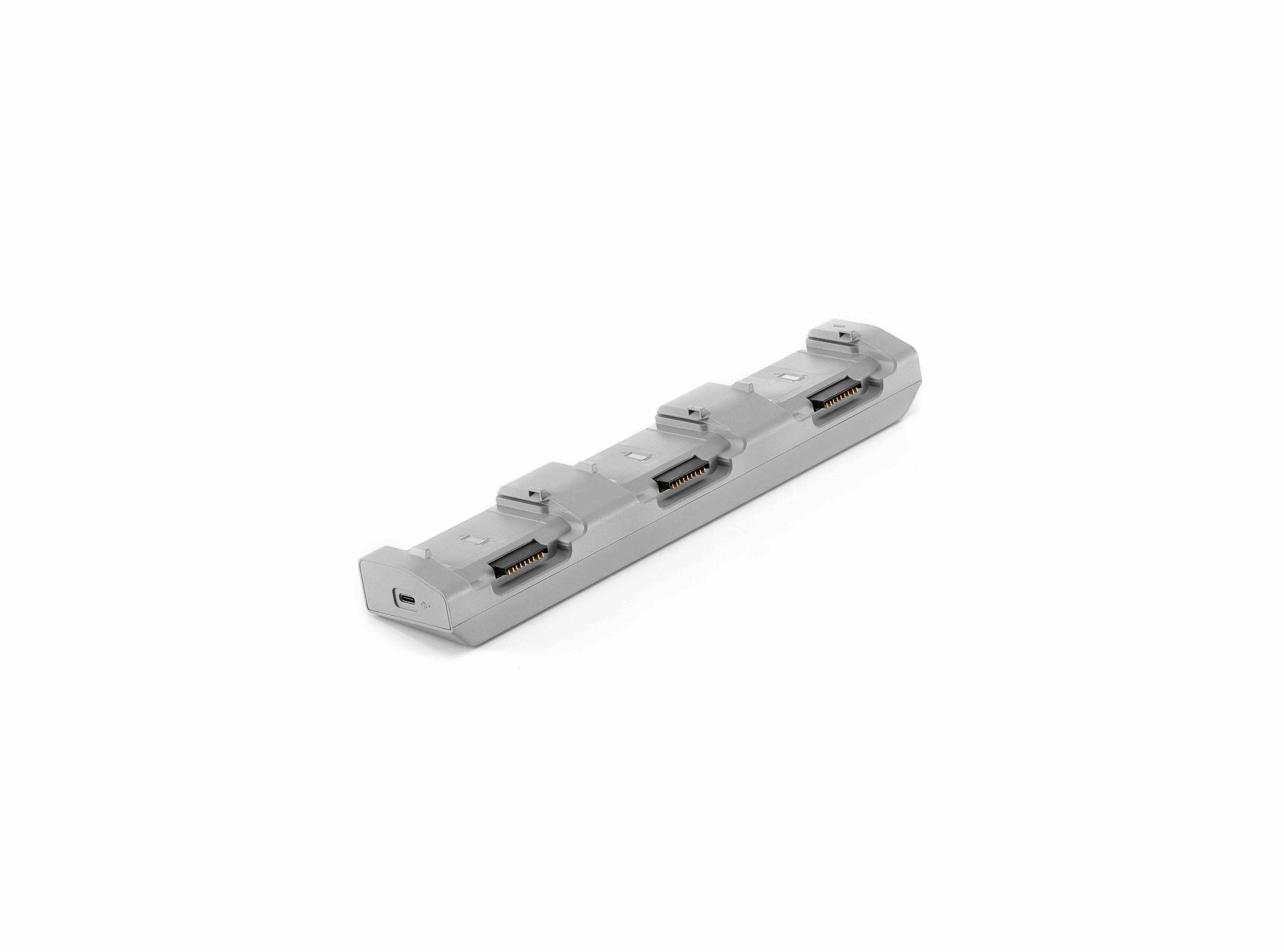 Der DJI Enterprise Ladehub CHX230-240 ist ein graues Gerät mit vier USB-Anschlüssen in einer Reihe, konzipiert zum intelligenten Laden und Erweitern der USB-Konnektivität für Matrice 4D/4TD Akkus, isoliert auf weißem Hintergrund dargestellt.
